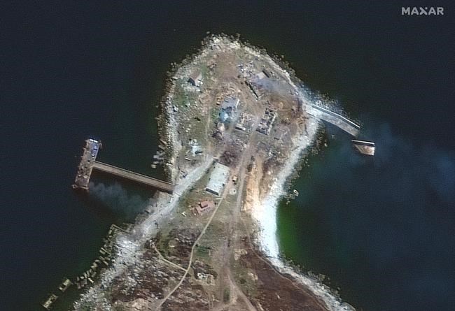 This image from Maxar Technologies shows a burning pier and buildings on the northern end of Snake Island, in the Black Sea, on Thursday June 30, 2022. (Satellite image ©2022 Maxar Technologies via AP)