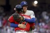 Los Angeles Dodgers first baseman Freddie Freeman (5) greets Atlanta Braves third base coach Ron Washington (37) at the end of the fourth inning at Truist Park Friday, June 24, 2022, in Atlanta. (Jason Getz/Atlanta Journal-Constitution via AP)