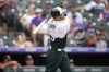 Colorado Rockies' C.J. Cron follows the flight of his three-run home run off Arizona Diamondbacks starting pitcher Zac Gallen during the sixth inning of a baseball game Sunday, July 3, 2022, in Denver. (AP Photo/David Zalubowski)