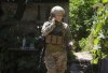 Ukrainian platoon commander Mariia talks on the phone in a position in the Donetsk region, Ukraine, Saturday, July 2, 2022. Ukrainian soldiers returning from the frontlines in eastern Ukraine’s Donbas region describe life during what has turned into a grueling war of attrition as apocalyptic. Mariia, 41, said that front-line conditions may vary depending on where a unit is positioned and how well supplied they are. (AP Photo/Efrem Lukatsky)