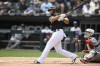 Chicago White Sox's Jose Abreu watches his RBI double during the first inning of a baseball game against the Minnesota Twins, Wednesday, July 6, 2022, in Chicago. (AP Photo/Paul Beaty)