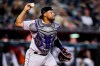 Colorado Rockies catcher Elias Diaz throws to second base for the out on Arizona Diamondbacks' Ketel Marte, who was attempting to steal during the fourth inning of a baseball game Thursday, July 7, 2022, in Phoenix. (AP Photo/Ross D. Franklin)