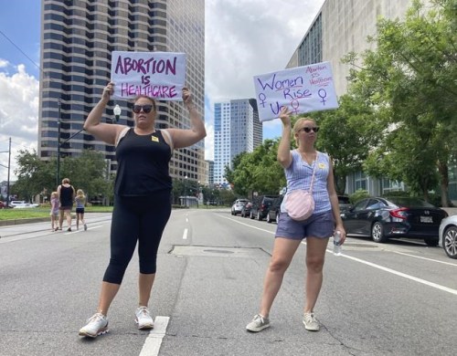 Protesters wave signs and demonstrate in support of abortion access in front of a New Orleans courthouse Friday July 8, 2022. Inside the courthouse a judge was hearing arguments on the state's trigger law designed to outlaw almost all abortions. Federal officials are looking into whether Canadian health workers could face legal risks for providing abortion services to Americans from states where the procedure has been outlawed. THE CANADIAN PRESS/AP, Rebecca Santana