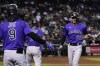 Colorado Rockies' Kris Bryant (23) celebrates his home run against the Arizona Diamondbacks with Brendan Rodgers (7) and Connor Joe (9) during the seventh inning of a baseball game Friday, July 8, 2022, in Phoenix. (AP Photo/Ross D. Franklin)