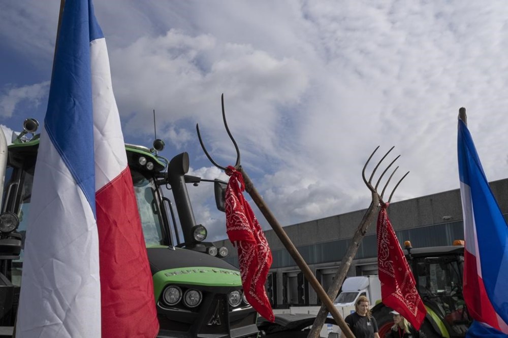FILE- Some 25 tractors were used to blockade a distribution center for supermarket chain Albert Heijn in the town of Zaandam, just north of Amsterdam, Monday, July 4, 2022. Dutch farmers angry at government plans to slash emissions used tractors and trucks Monday to blockade supermarket distribution centers, the latest actions in a summer of discontent in the country's lucrative agricultural sector. (AP Photo/Peter Dejong, File)