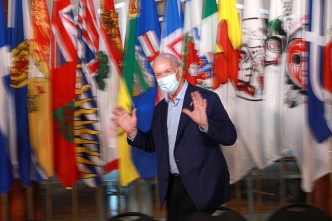 Premier John Horgan gestures during a break from a meeting of Canada's premiers at the Songhees Wellness Centre in Victoria, B.C., on Monday, July 11, 2022 THE CANADIAN PRESS/Chad Hipolito