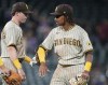 San Diego Padres first baseman Jake Cronenworth, left, congratulates second baseman C.J. Abrams after a baseball game against the Colorado Rockies, Monday, July 11, 2022, in Denver. (AP Photo/David Zalubowski)
