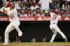 Los Angeles Angels' Shohei Ohtani, right, of Japan, prepares for his at-bat as Mike Trout stands in the batter's box during the third inning of a baseball game against the Houston Astros Tuesday, July 12, 2022, in Anaheim, Calif. (AP Photo/Jae C. Hong)