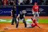 Cincinnati Reds' Brandon Drury (22) watches as Donovan Solano (7) slides past New York Yankees catcher Jose Trevino to score on a single by Jonathan India during the ninth inning of a baseball game Tuesday, July 12, 2022, in New York. The Reds won 4-3. (AP Photo/Frank Franklin II)