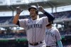Seattle Mariners' Eugenio Suarez reacts after hitting a three-run home run in the first inning of the first game of a baseball doubleheader against the Washington Nationals, Wednesday, July 13, 2022, in Washington. (AP Photo/Patrick Semansky)
