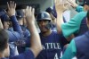 Seattle Mariners' Julio Rodriguez is greeted in the dugout after he scored on a single by Carlos Santana during the first inning of the team's baseball game against the Toronto Blue Jays, Thursday, July 7, 2022, in Seattle. (AP Photo/Ted S. Warren)
