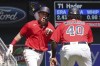 Minnesota Twins' Jose Miranda, right, is greeted by third base coach Tommy Watkins after Miranda hit a three-run walkoff home run off Milwaukee Brewers relief pitcher Josh Hader in the ninth inning of a baseball game, Wednesday, July 13, 2022, in Minneapolis. The Twins won 4-1. (AP Photo/Jim Mone)