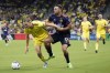 Seattle Sounders' Will Bruin (17) grabs Nashville SC's Walker Zimmerman during the second half of an MLS soccer match Wednesday, July 13, 2022, in Nashville, Tenn. (AP Photo/Mark Humphrey)