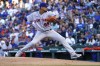 New York Mets starting pitcher Carlos Carrasco winds up during the first inning of the team's baseball game against the Chicago Cubs on Thursday, July 14, 2022, in Chicago. (AP Photo/Charles Rex Arbogast)