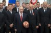 FILE - Russian President Vladimir Putin, center left, and Russia's soccer team head coach Stanislav Cherchesov, center right, goalkeeper Igor Akinfeev, second row center, soccer players Alexander Golovin, second from left, Artem Dzyuba, second row third from left, pose for a photo during the State Prize awards ceremony in Kremlin in Moscow, Russia, Saturday, July 28, 2018. World soccer body FIFA and European authority UEFA banned Russian national and club teams from their competitions, taking Russia's men's national team out of World Cup qualifying playoffs. Russia remains barred from Europe's leading soccer competitions including the Champions League, after the Court of Arbitration for Sport rejected appeals by the national soccer federation and four clubs on Friday, July 15, 2022. (AP Photo/Pavel Golovkin, Pool, File)