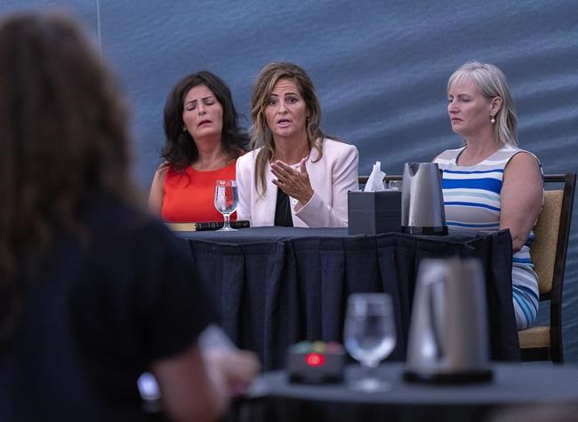 Lisa Banfield, the common-law wife of Gabriel Wortman, is flanked by her sisters Janice Banfield (left), and Maureen Banfield (right) as she testifies at the Mass Casualty Commission inquiry into the mass murders in rural Nova Scotia on April 18/19, 2020, in Halifax on Friday, July 15, 2022. Wortman, dressed as an RCMP officer and driving a replica police cruiser, murdered 22 people. THE CANADIAN PRESS/Andrew Vaughan