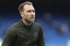 FILE - Brentford's Christian Eriksen warms up before their English Premier League soccer match against Chelsea, at the Stamford Bridge stadium in London, April 2, 2022. Manchester United has signed Denmark playmaker Christian Eriksen to a three-year contract on Friday, July 15. The 30-year-old Eriksen played for Brentford in the second half of last season, joining the London club almost eight months after collapsing from cardiac arrest at the European Championship. (AP Photo/Ian Walton)