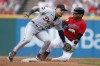 Cleveland Guardians' Jose Ramirez , right, slides safely into second base after hitting an RBI single and advancing on the throw, as Detroit Tigers' Javier Baez attempts a tag during the first inning of a baseball game Friday, July 15, 2022, in Cleveland. (AP Photo/Ron Schwane)