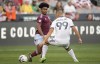 Colorado Rapids midfielder Ralph Priso, left, passes the ball as LA Galaxy forward Dejan Joveljić defends during the first half of an MLS soccer match Saturday, July 16, 2022, in Commerce City, Colo. (AP Photo/David Zalubowski)