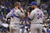 New York Mets relief pitcher Tommy Hunter, right, talks with catcher Patrick Mazeika during the sixth inning of a baseball game against the Chicago Cubs in Chicago, Sunday, July 17, 2022. (AP Photo/Nam Y. Huh)