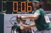 A pitch clock is deployed to restrict pitcher preparation times during a minor league baseball game between the Brooklyn Cyclones and Greensboro Grasshoppers, Wednesday, July 13, 2022, in the Coney Island neighborhood of the Brooklyn borough of New York. Major League Baseball is considering a pitch clock for next year along with shift limits, larger bases and restrictions on pickoff attempts.  (AP Photo/John Minchillo)
