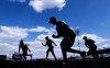 FILE - Quad Cities River Bandits players warm up before a Class-A Midwest League baseball game against the Cedar Rapids Kernels in Cedar Rapids, Iowa, Monday, May 13, 2019. Leaders of the Senate Judiciary Committee have asked baseball Commissioner Rob Manfred to explain the impact of potential legislation stripping the sport’s antitrust exemption from covering the sport’s relationship with minor league players. (AP Photo/Charlie Neibergall, File)