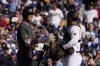 American League designated hitter Shohei Ohtani, left, of the Los Angeles Angels, is greeted by National League's catcher Wilson Contreras, of the Chicago Cubs, before taking an at bat during the first inning of the MLB All-Star baseball game, Tuesday, July 19, 2022, in Los Angeles. (AP Photo/Mark J. Terrill)