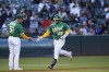 Oakland Athletics' Ramón Laureano (22) celebrates with third base coach Darren Bush (51) after hitting a solo home run against the Texas Rangers during the fifth inning of a baseball game in Oakland, Calif., Friday, July 22, 2022. (AP Photo/Godofredo A. Vásquez)