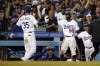 Los Angeles Dodgers' Cody Bellinger (35) returns to the dugout, to greetings from Mookie Betts (50) and manager Dave Roberts, after his grand slam during the eighth inning of the team's baseball game against the San Francisco Giants on Friday, July 22, 2022, in Los Angeles. (AP Photo/Marcio Jose Sanchez)