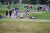 Fans and tournament staff make their way off the course after play was suspended due to inclement weather during the third round of the 3M Open golf tournament at the Tournament Players Club in Blaine, Minn., Saturday, July 23, 2022. (AP Photo/Abbie Parr)