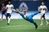 Vancouver Whitecaps goalkeeper Isaac Boehmer dives for the ball as it gets past him but bounces off the post and stays out of the goal during the first half of an MLS soccer game against the Chicago Fire in Vancouver, on Saturday, July 23, 2022. THE CANADIAN PRESS/Darryl Dyck