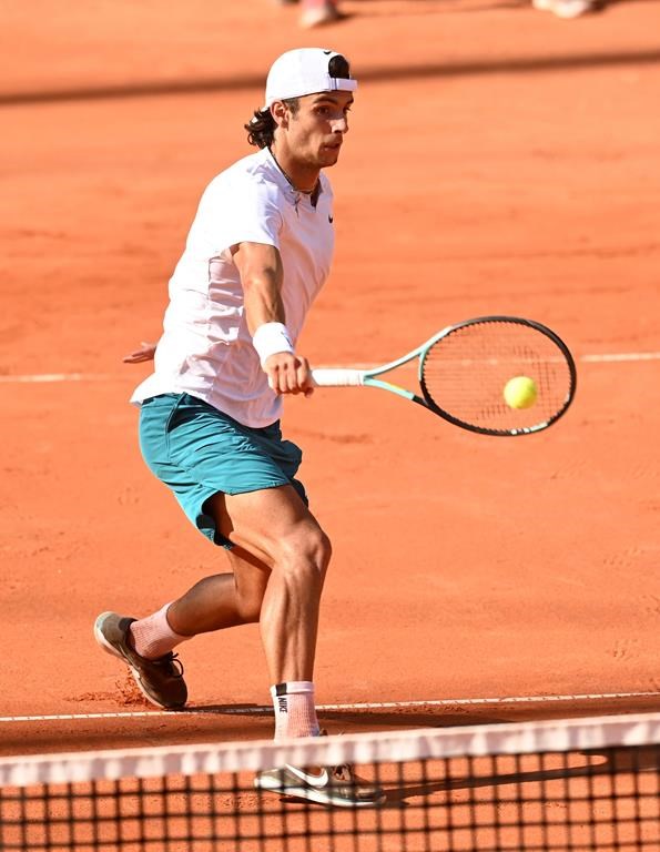 Italy's Lorenzo Musetti returns the ball to Spain's Carlos Alcaraz, during the final match of the Hamburg tennis tournament, Germany, Sunday July 24, 2022. (Daniel Bockwoldt/dpa via AP)