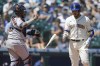 Seattle Mariners' Eugenio Suarez, right, tosses his bat as Houston Astros catcher Martin Maldonado returns the ball after Suarez struck out swinging to end the first inning of a baseball game, Sunday, July 24, 2022, in Seattle. (AP Photo/Ted S. Warren)