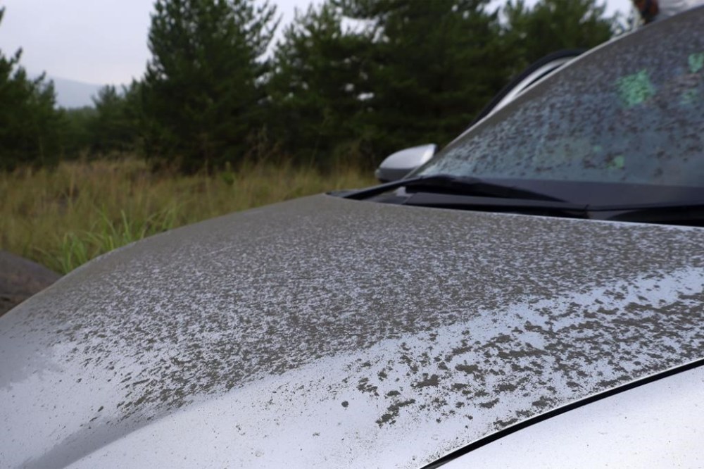 Ash from Sakurajima volcano is seen on a vehicle in Kagoshima, southern island of Kyushu, Japan Monday, July 25, 2022. The volcano erupted Sunday night, spewing ash and rocks, causing dozens of residents in nearby towns to evacuate to a safer part of the region. (Kyodo News via AP)