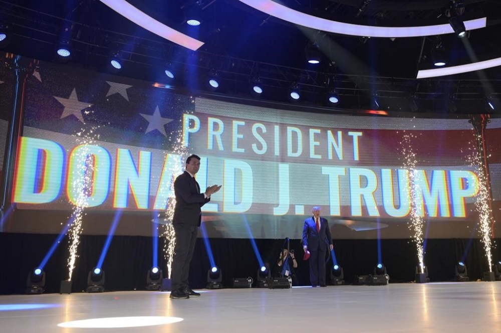 Former President Donald Trump, right, reacts as he walks to the stage before addressing attendees during the Turning Point USA Student Action Summit, Saturday, July 23, 2022, in Tampa, Fla. (AP Photo/Phelan M. Ebenhack)
