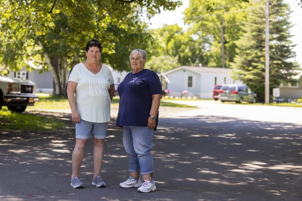 Sharon Ruth, left, and Sandy Lees pose for a portrait in the Ridgeview Homes mobile home community in Lockport, N.Y., June 23, 2022, Ruth and Lees, president and vice president of their neighborhood association, have organized a rent strike in reaction to a proposed rent increase being introduced by new owners of the mobile home park.