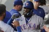 Texas Rangers' Adolis Garcia is greeted in the dugout after he hit a solo home run during the sixth inning of a baseball game against the Seattle Mariners, Monday, July 25, 2022, in Seattle. (AP Photo/Ted S. Warren)