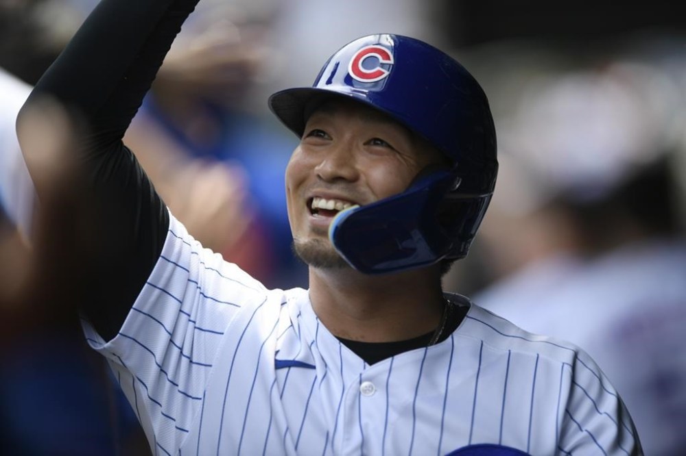 Chicago Cubs' Seiya Suzuki celebrates with teammates in the dugout after scoring on a two RBI double hit by Ian Happ during the first inning of a baseball game against the Pittsburgh Pirates Tuesday, July 26, 2022, in Chicago. (AP Photo/Paul Beaty)