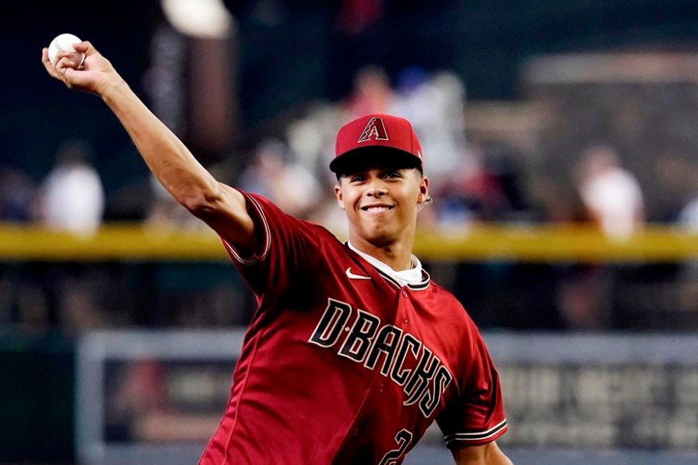Arizona Diamondbacks' first-round draft pick Druw Jones throws out the first pitch prior to the team's baseball game against the Washington Nationals on Saturday, July 23, 2022, in Phoenix. (AP Photo/Ross D. Franklin)