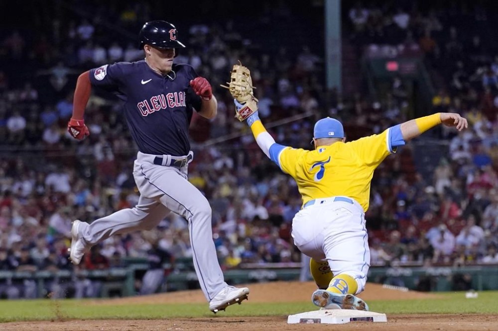 Cleveland Guardians' Myles Straw, left, grounds out to Boston Red Sox first baseman Christian Vazquez, right, during the eighth inning of a baseball game at Fenway Park, Tuesday, July 26, 2022, in Boston. (AP Photo/Charles Krupa)