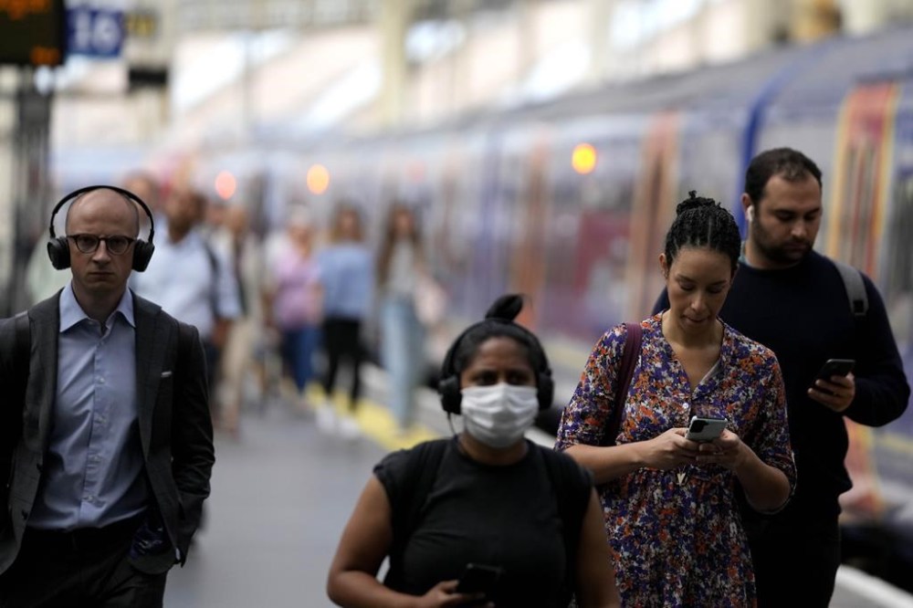 Travellers leave a train at Waterloo Station as members of the Rail, Maritime and Transport union (RMT) began fresh nationwide strikes in a bitter dispute over pay, jobs and conditions, in London, Wednesday, July 27, 2022. Train companies said only about a fifth of services across the country were due to run on Wednesday. (AP Photo/Frank Augstein)