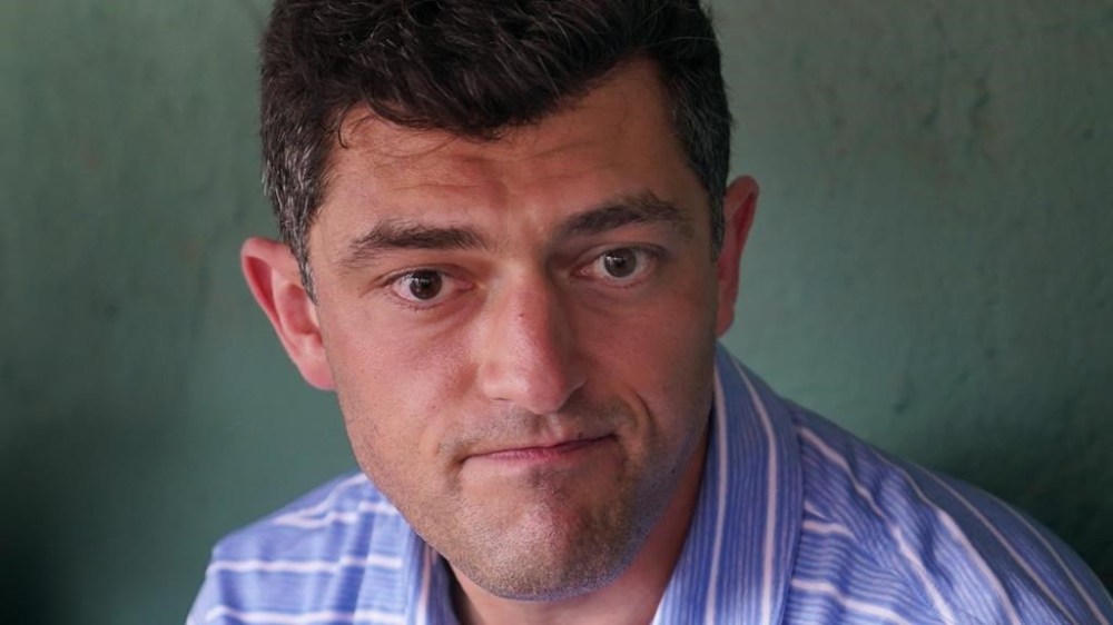 Chaim Bloom, Boston Red Sox chief baseball officer, talks with reporters in the dugout prior to a baseball game against the Cleveland Guardians at Fenway Park, Wednesday, July 27, 2022, in Boston. The Red Sox dropped into last place in the American League East Tuesday evening following a loss to the Guardians. (AP Photo/Charles Krupa)
