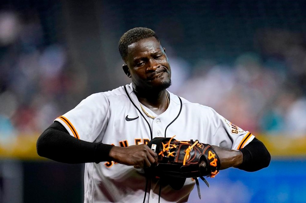 San Francisco Giants relief pitcher Yunior Marte walks off the field after being replaced during the eighth inning of a baseball game against the Arizona Diamondbacks Tuesday, July 26, 2022, in Phoenix. The Diamondbacks won 7-3. (AP Photo/Ross D. Franklin)