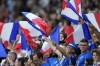 France supporters wave flags during the Women Euro 2022 semifinal soccer match between Germany and France at Stadium MK in Milton Keynes, England, Wednesday, July 27, 2022. (AP Photo/Alessandra Tarantino)
