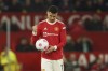 FILE - Manchester United's Cristiano Ronaldo holds the ball after Chelsea's Marcos Alonso scored his side's first goal during the English Premier League soccer match between Manchester United and Chelsea, at Old Trafford Stadium, Manchester, England, Thursday, April, 2022. By Thursday, July 21, 2022, Cristiano Ronaldo has not yet returned to preseason training with Manchester United because of what has been publicly described as “personal reasons.” Ronaldo reportedly wants out after only one season back at Old Trafford because United is no longer in the Champions League or in shape to compete with the best teams in England. (AP Photo/Dave Thompson, File)