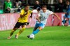 Donyell Malen of Borussia Dortmund, left, and Niklas Lang of 1860 Munich vie for the ball, during the German Soccer Cup 1st round match betwen 1860 Munich and Borussia Dortmund, in Munich, Germany, Friday, July 29, 2022. (Matthias Balk/dpa via AP)
