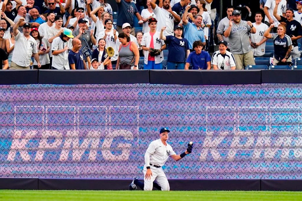 Fans cheer after New York Yankees' Aaron Judge caught a ball hit by Kansas City Royals' MJ Melendez for an out during the first inning of a baseball game Friday, July 29, 2022, in New York. (AP Photo/Frank Franklin II)