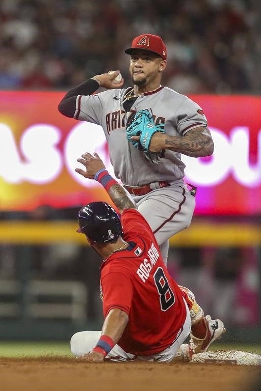 Arizona Diamondbacks second baseman Ketel Marte turns a double play over Atlanta Braves Eddie Rosario (8) during the sixth inning of a baseball game Friday, July 29, 2022, in Atlanta. Orland Arcia was out at first. (AP Photo/Brett Davis)