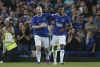 Everton's Mason Holgate right, celebrates the goal of fund raiser Paul Stratton during a pre-season friendly soccer match at Goodison Park, Liverpool, England, Friday, July 29, 2022. An Everton fan who has been working to help Ukrainian refugees was brought on to take a penalty during their pre-season friendly against Dynamo Kyiv at Goodison Park. Paul Stratton, who used his time off from working for Liverpool Council to travel to Poland and hand out supplies to people fleeing the war, came on towards the end of the ‘match for peace’. (Barrington Coombs/PA via AP)