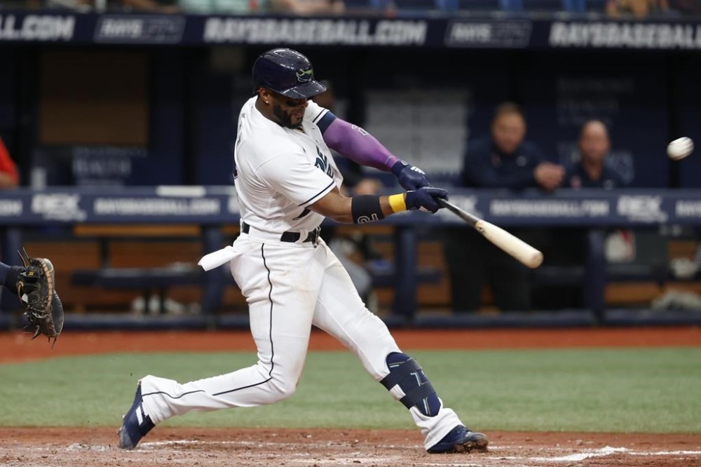 Tampa Bay Rays' Yandy Diaz hits a home run against the Cleveland Guardians during the fifth inning of a baseball game Saturday, July 30, 2022, in St. Petersburg, Fla. (AP Photo/Scott Audette)